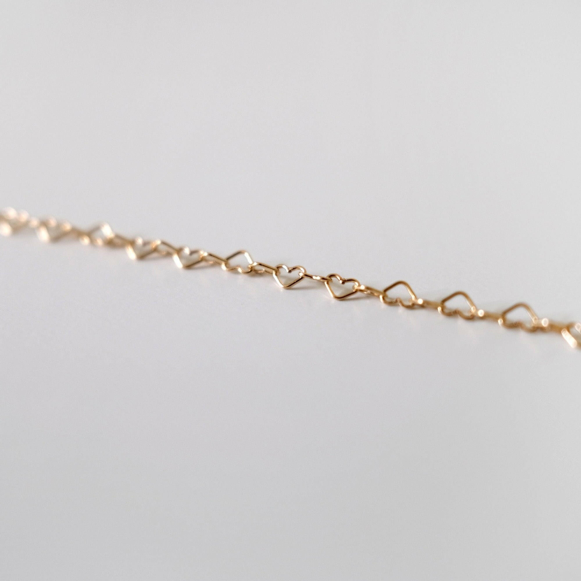Zoomed-in view showing individual heart links in gold filled chain