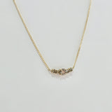 Overhead view of diamond cluster pendant glistening under light – fine craftsmanship in solid gold