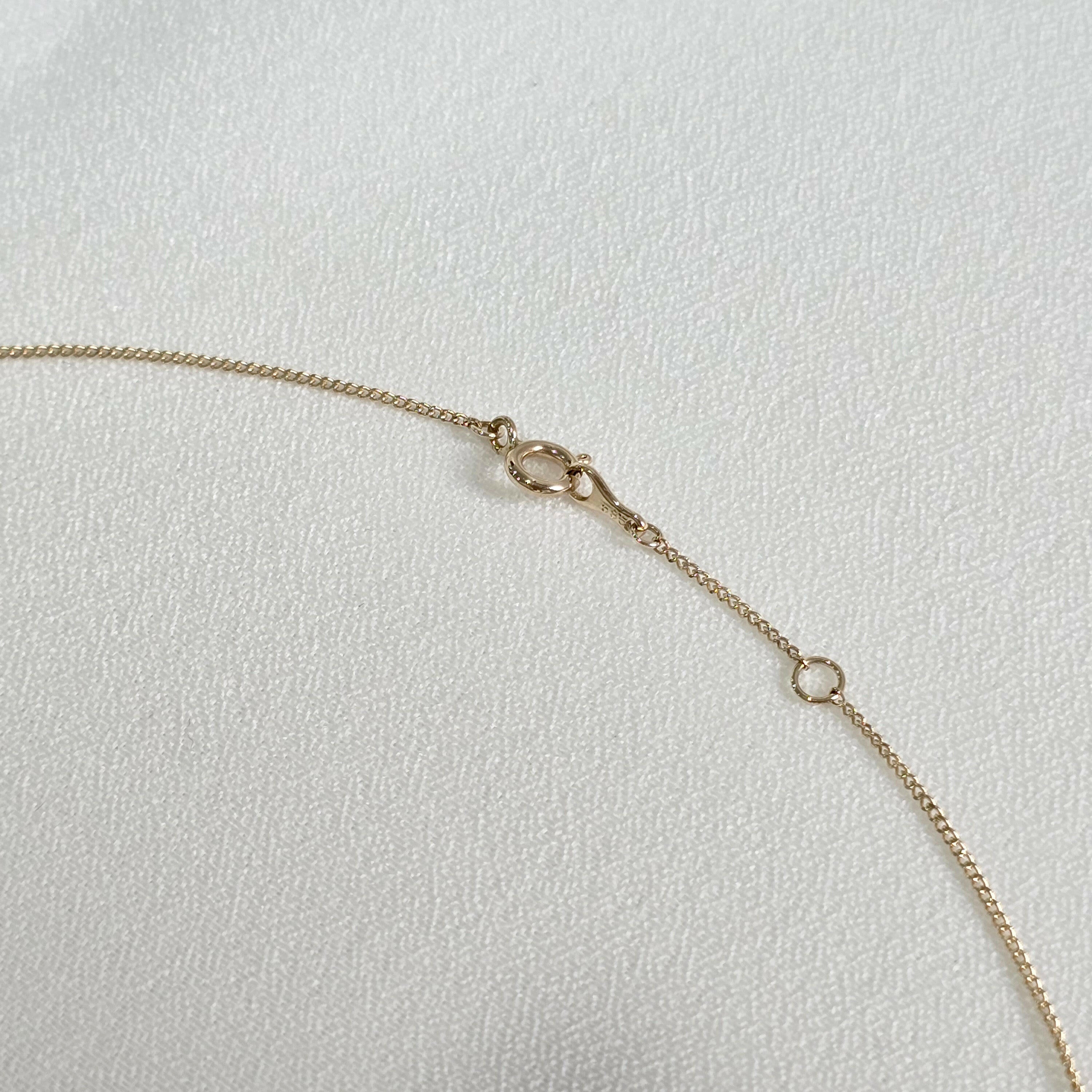 Close-up of 14K gold spring clasp with extender – secure and hypoallergenic design