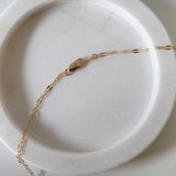 Close-up showing clasp and chain texture with warm lighting