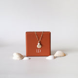 Gold filled necklace with shell pendant, pearl, and coral beads