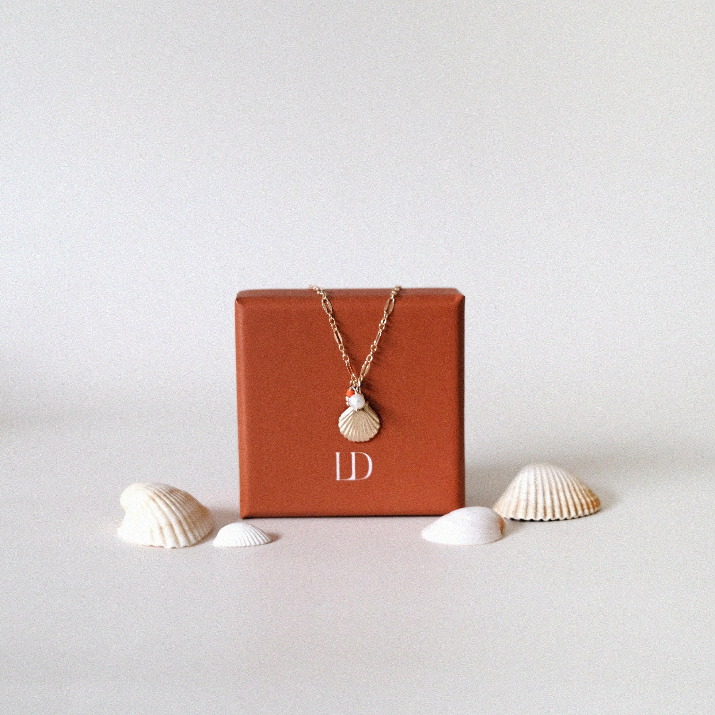 Gold filled necklace with shell pendant, pearl, and coral beads