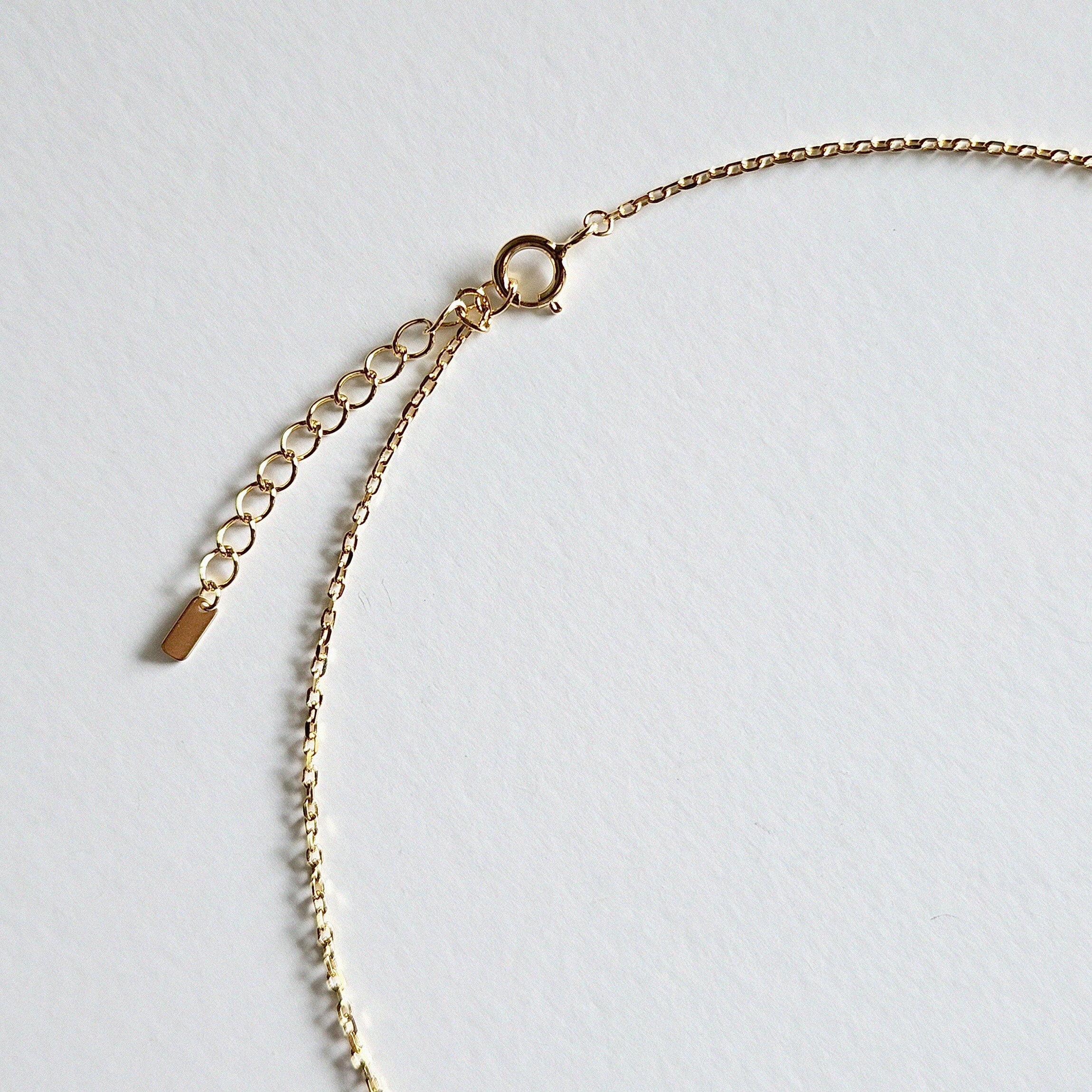 Close-up of clasp and extension chain on sterling silver necklace