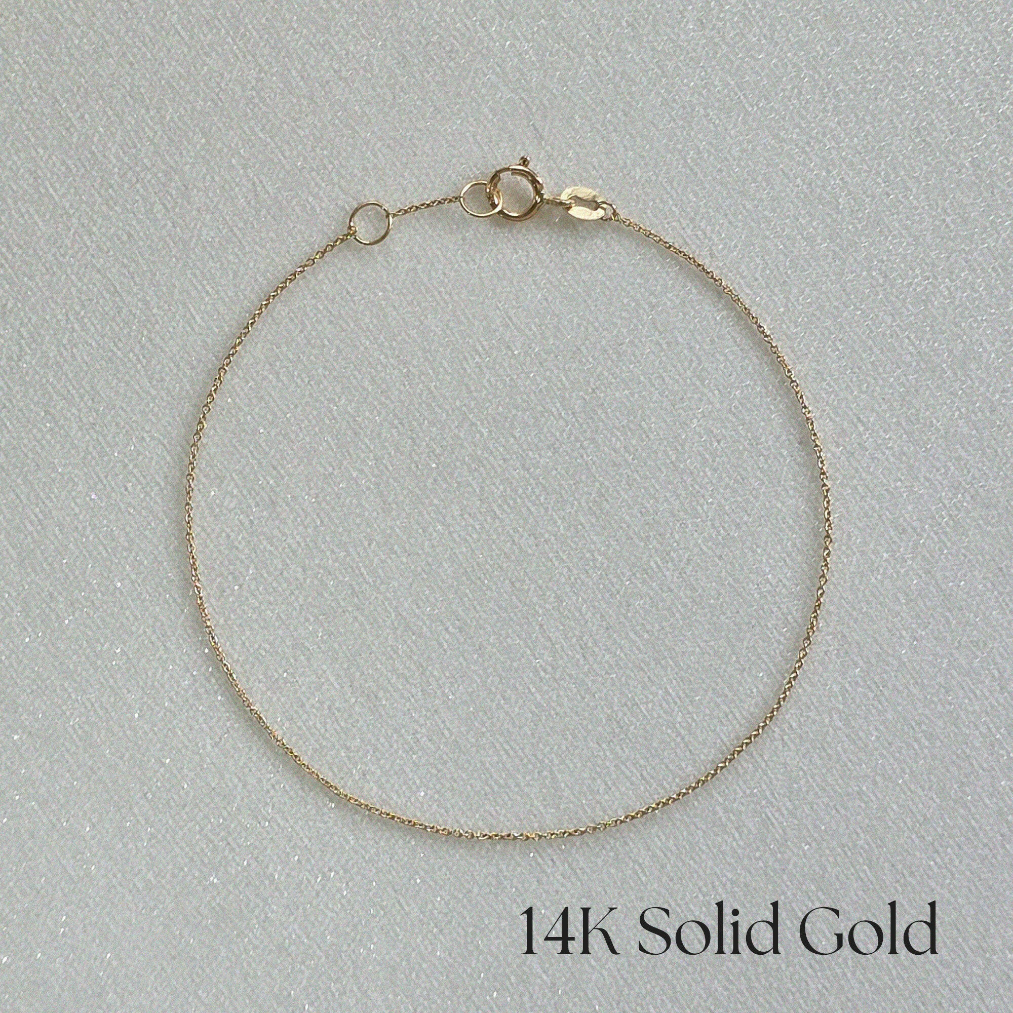 Ariel shot of 14K Paris Chain Bracelet displayed flat on a white background