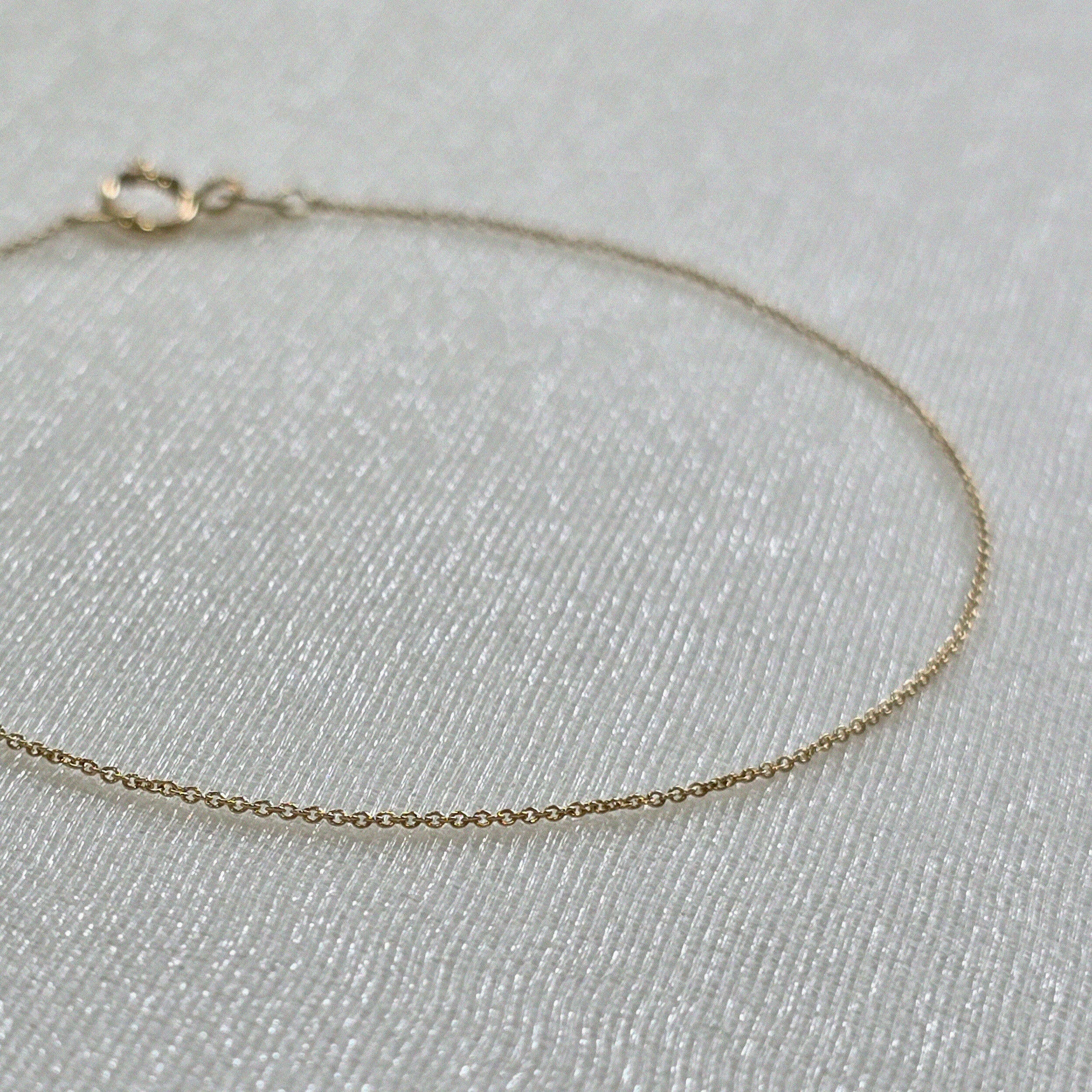 Macro detail of petite chain links with high-polish shine