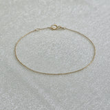 Delicate Paris link bracelet laid out to show fine detail and shine