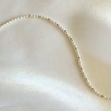Aerial view highlighting the alternating pearls and gold beads on the chain