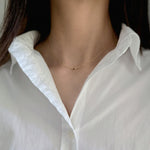 Elegant crystal necklace featuring black cubic zirconia and gemstone on a dainty chain with a petite pendant.