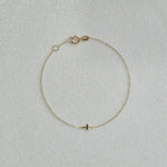 14K Petite Cross Bracelet with small cross charm displayed on a white background