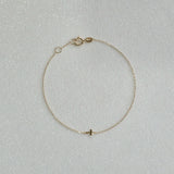 14K Petite Cross Bracelet with small cross charm displayed on a white background