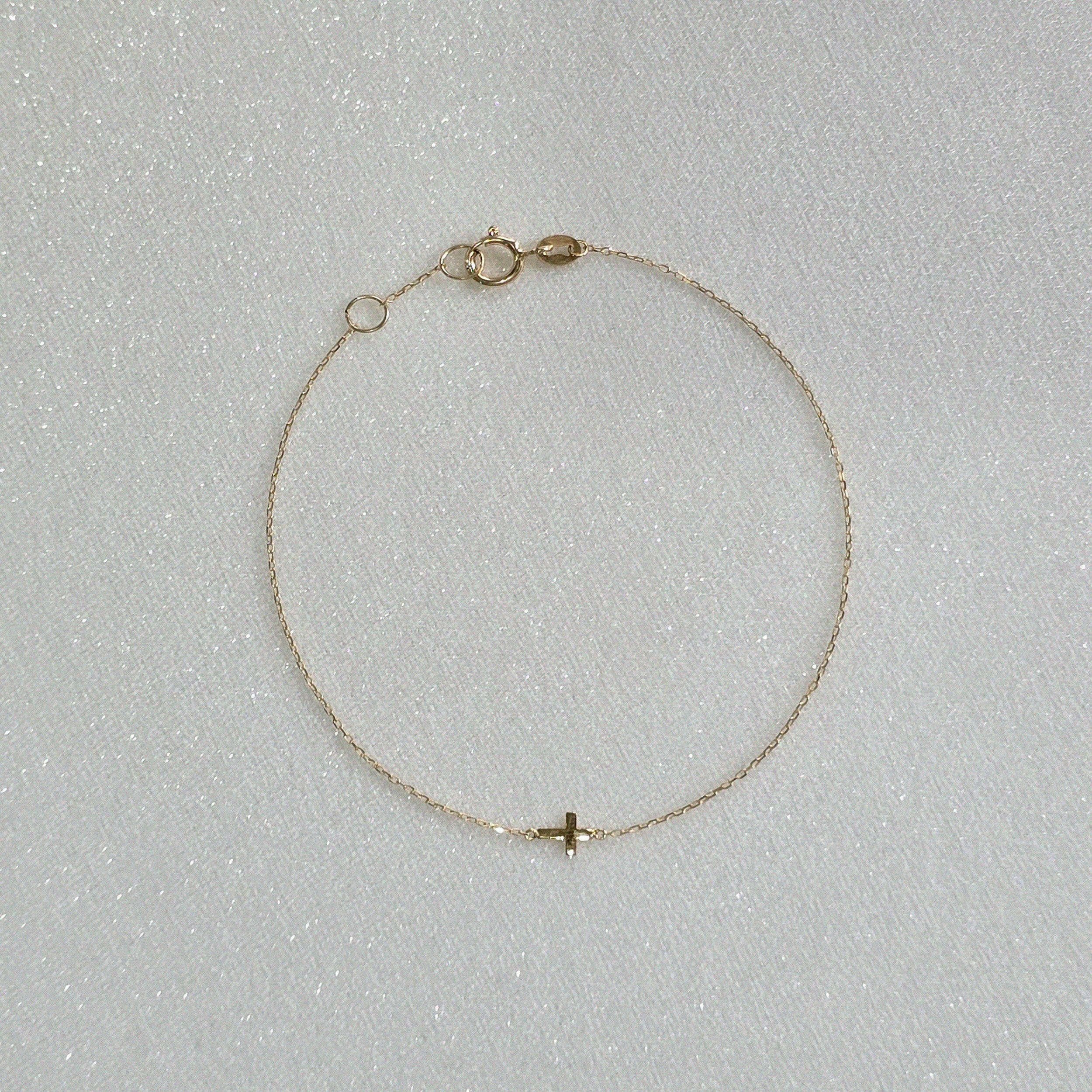 14K Petite Cross Bracelet with small cross charm displayed on a white background