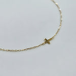 Minimalist gold bracelet featuring a 4mm x 5mm cross on a fine chain