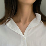 Model wearing minimalist gold necklace with 3mm CZ pendant for elegant daily styling