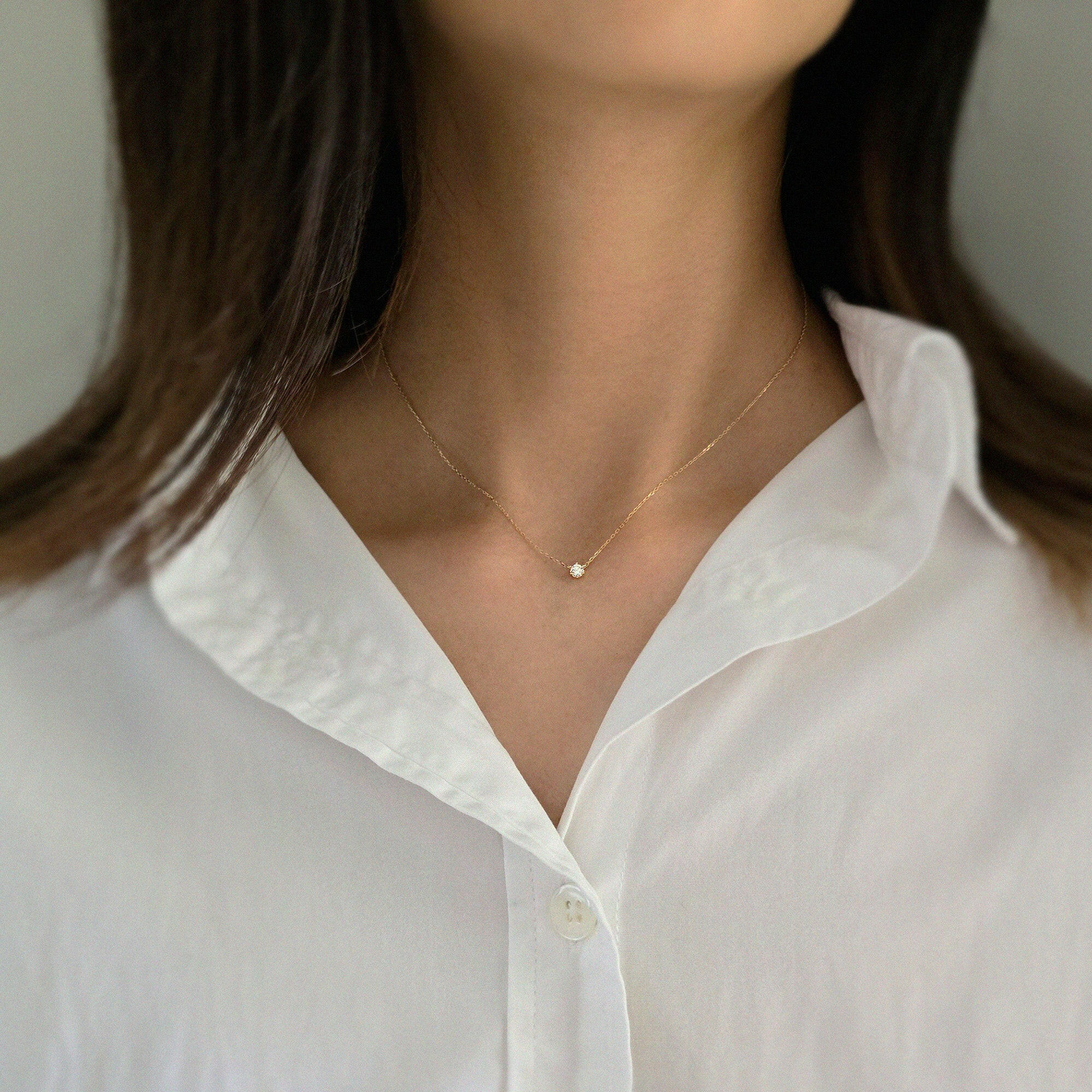 Model wearing minimalist gold necklace with 3mm CZ pendant for elegant daily styling