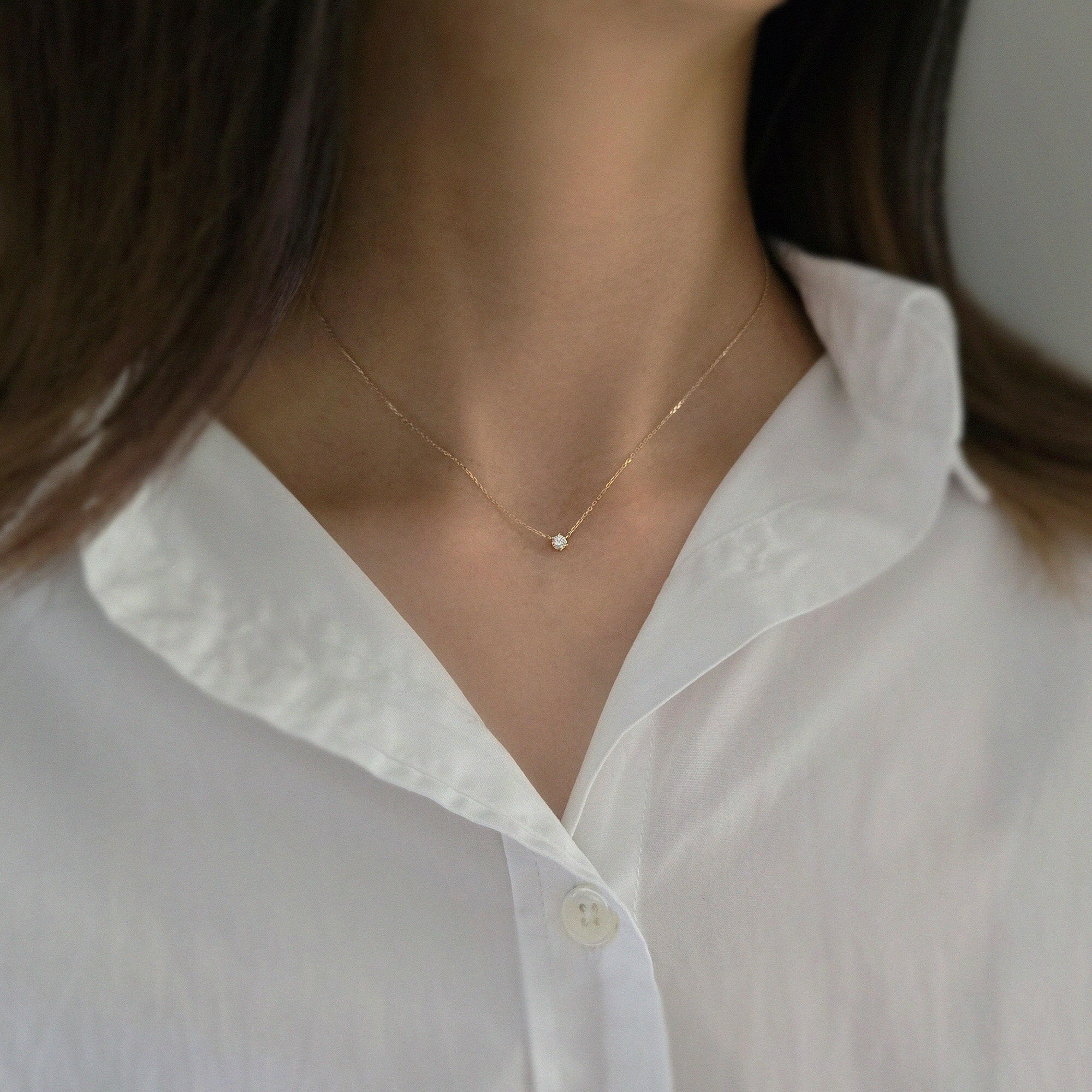 Model wearing minimalist gold necklace with 3mm CZ pendant for elegant daily styling