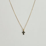 Close-up of 14K gold cross pendant with 4mm–7.5mm diamond in high-polish finish