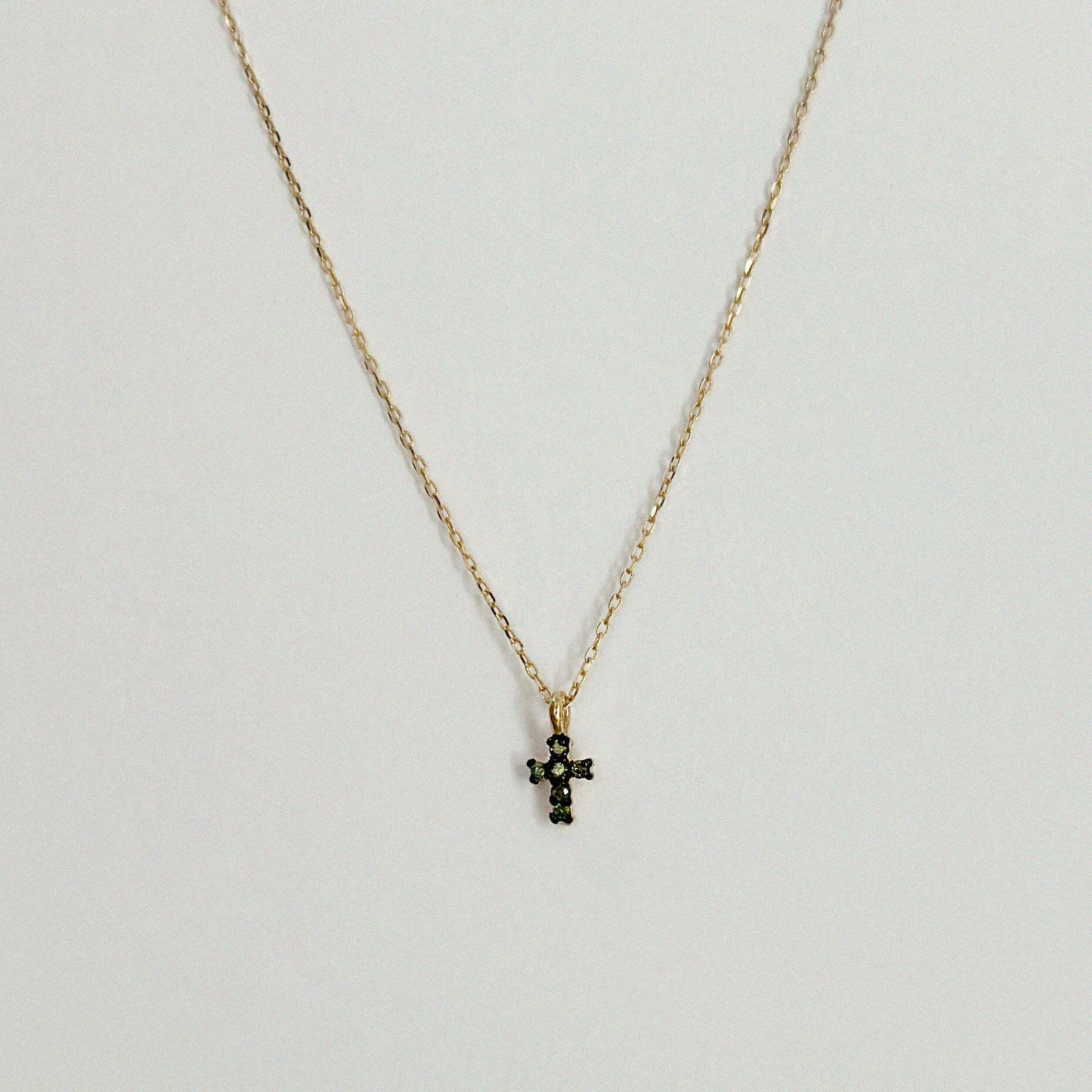 Close-up of 14K gold cross pendant with 4mm–7.5mm diamond in high-polish finish