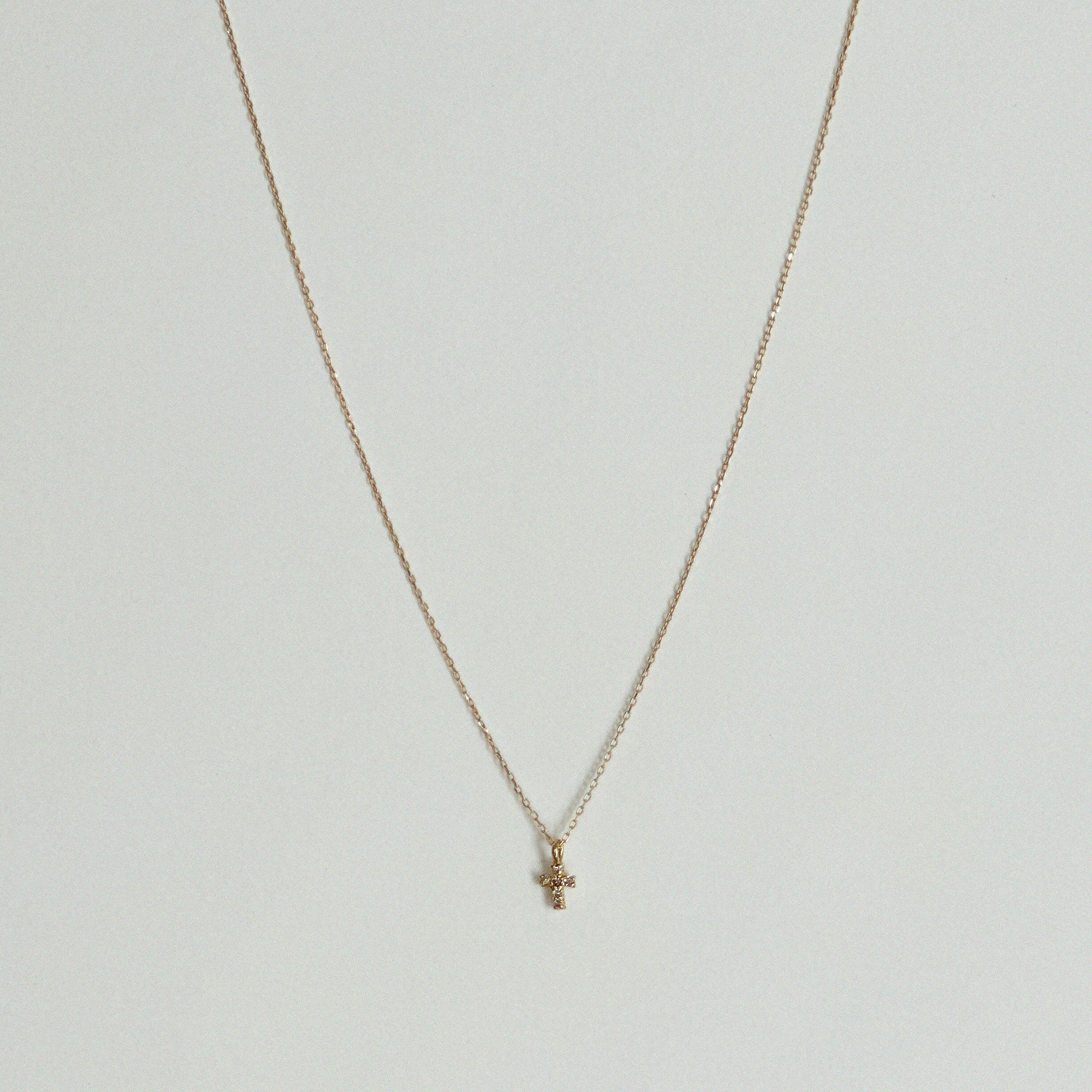 14K Petite Diamond Cross Necklace with clear stone, dainty cross pendant photographed
