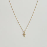Close-up of 14K gold cross pendant with 4mm–7.5mm diamond in high-polish finish