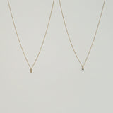 14K Petite Diamond Cross Necklace with clear or green stone, dainty cross pendant photographed