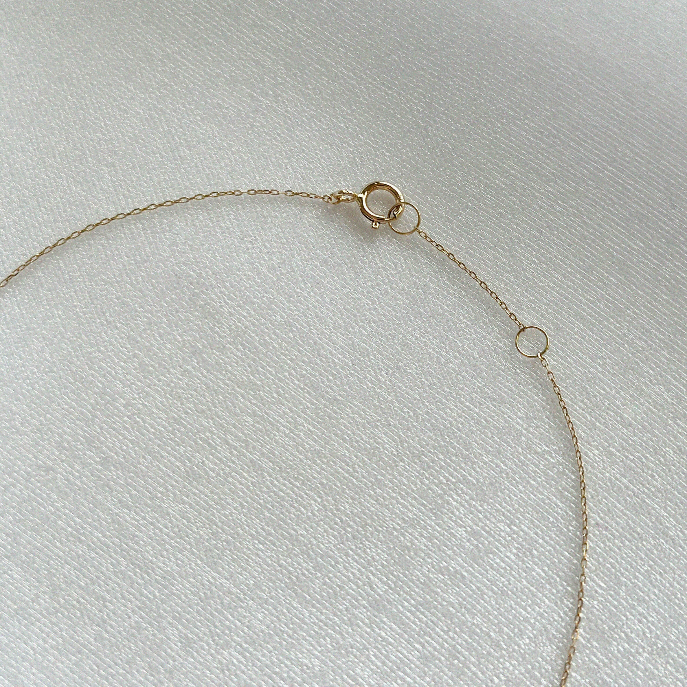 Detail view of 14K gold chain links and clasp on Petite Diamond Cross Necklace