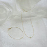 14K Petite Diamond Bracelet and matching necklace displayed on soft white satin fabric
