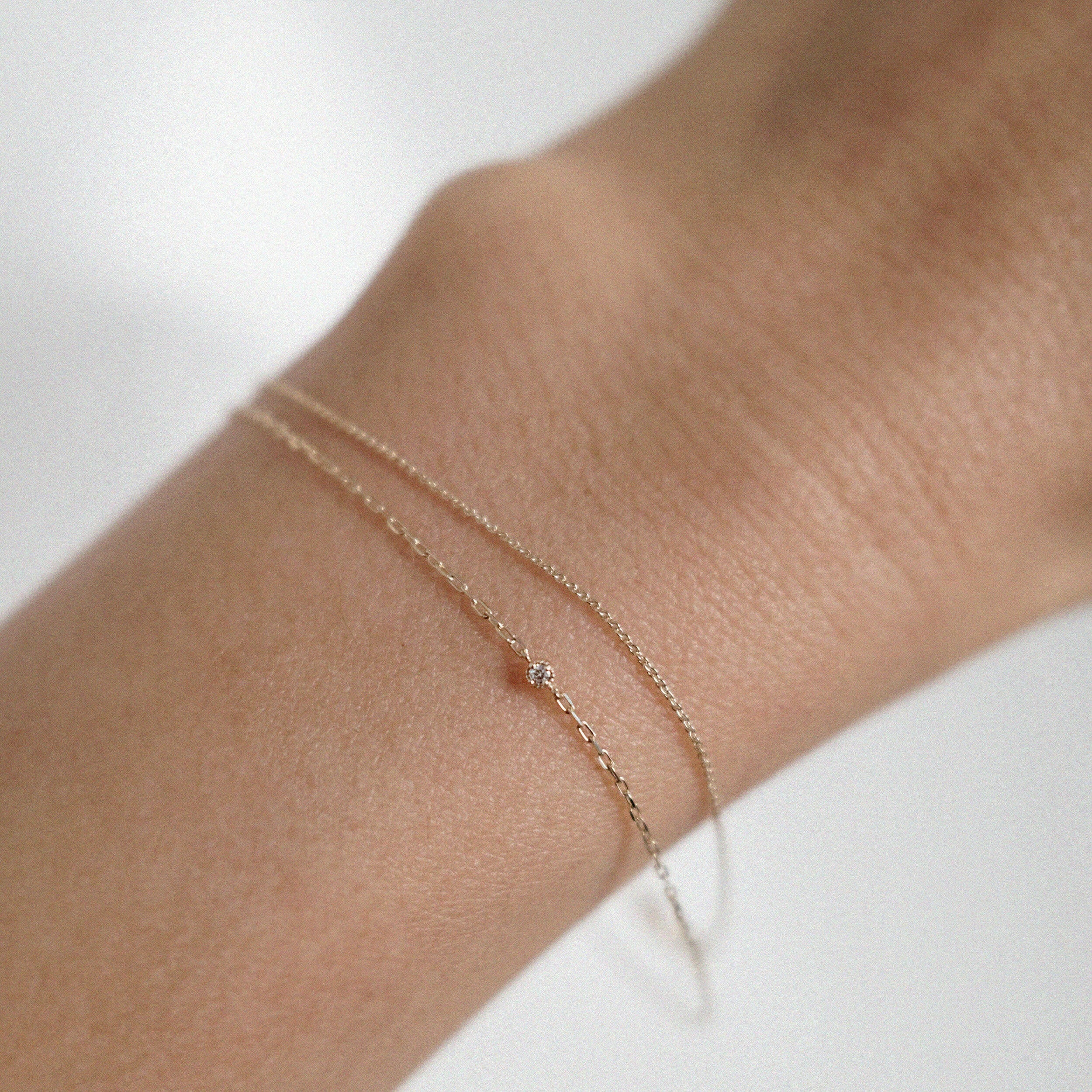 Minimal diamond chain bracelet styled with other fine gold pieces