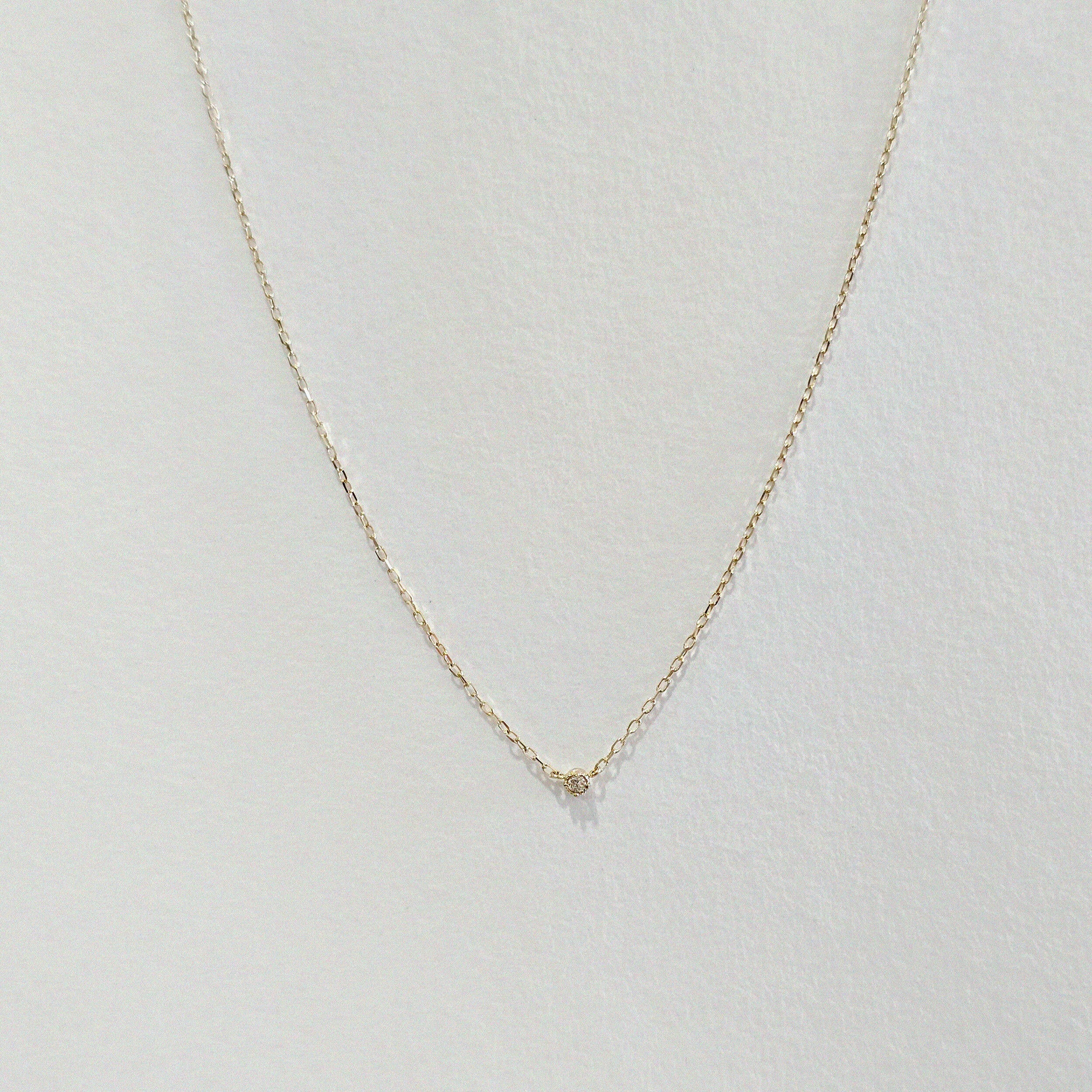 Front-facing view of the Petite Diamond Necklace showing full chain and centered diamond