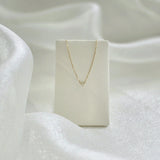 Petite Diamond Necklace displayed on cream leather necklace stand
