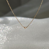 Macro shot of 1.5mm diamond bezel setting in 14K yellow gold
