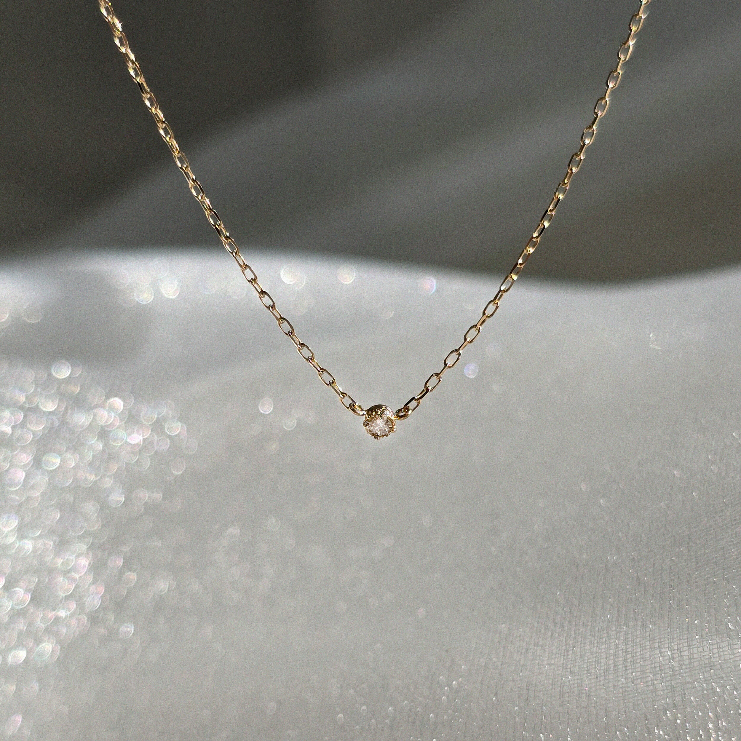 Macro shot of 1.5mm diamond bezel setting in 14K yellow gold