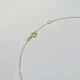 Close-up of spring ring clasp and extension links of 14K gold chain