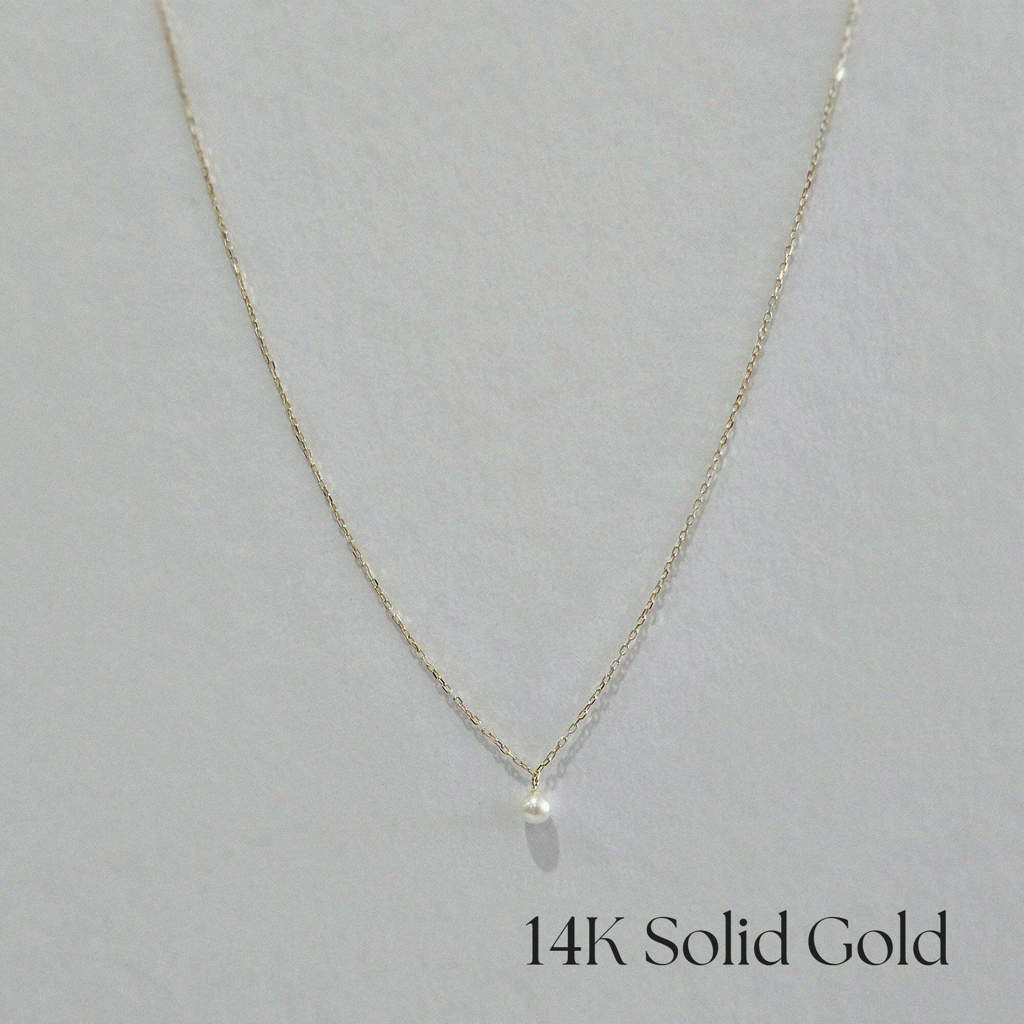 Front-facing image of full necklace laid out in U-shape to show complete chain and pendant placement