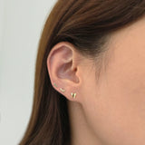 Creative ear styling featuring whimsical gold lash stud