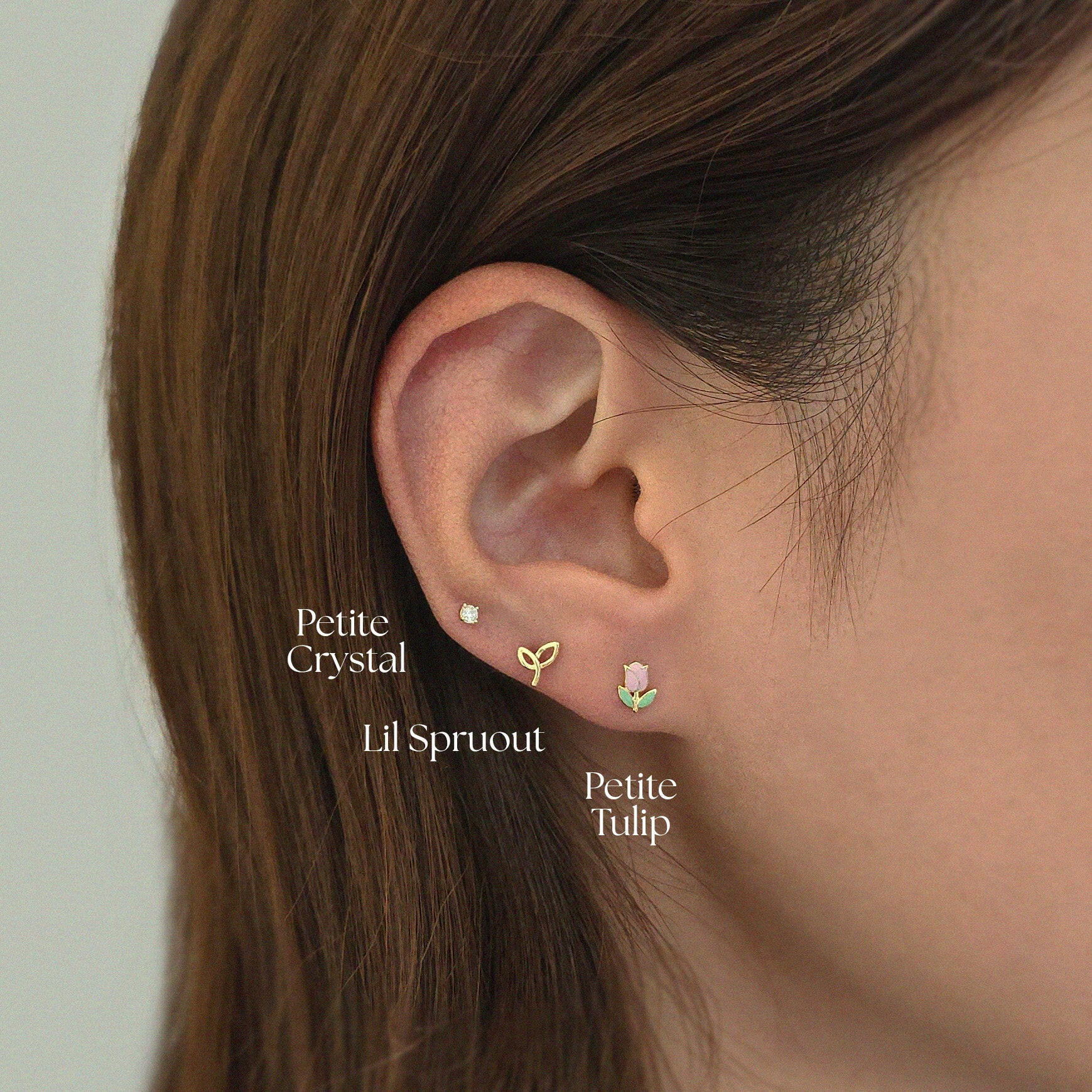 Model pairing Petite Crystal Cartilage Earring with small gold studs