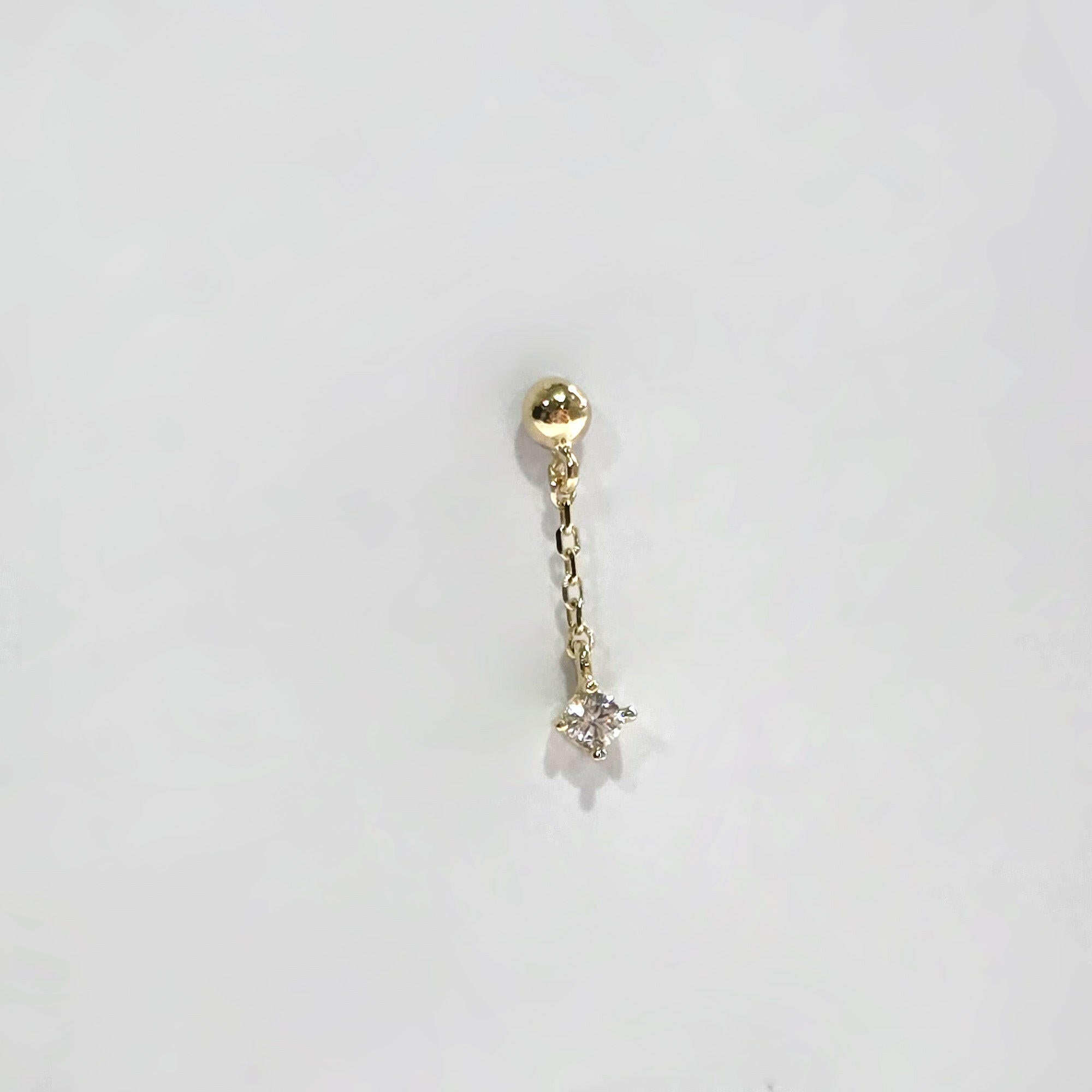 Close-up profile shot of the drop earring highlighting chain movement and polish