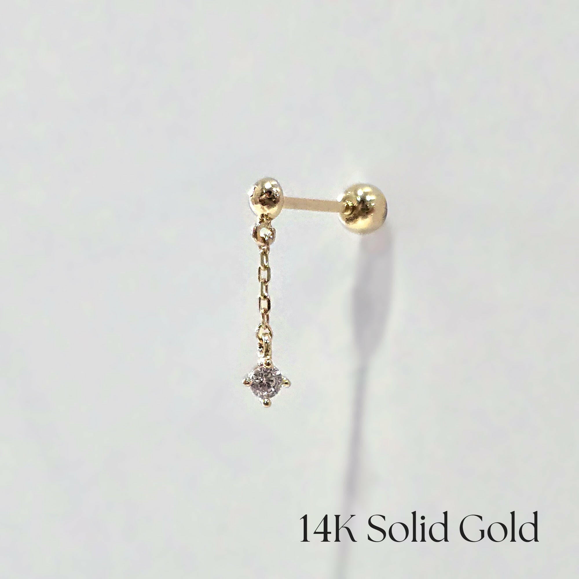 Side view of the Petite Crystal Drop Cartilage Earring showing delicate chain and cubic zirconia on white background