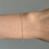 Ultra-thin gold bracelet styled casually on wrist with everyday attire