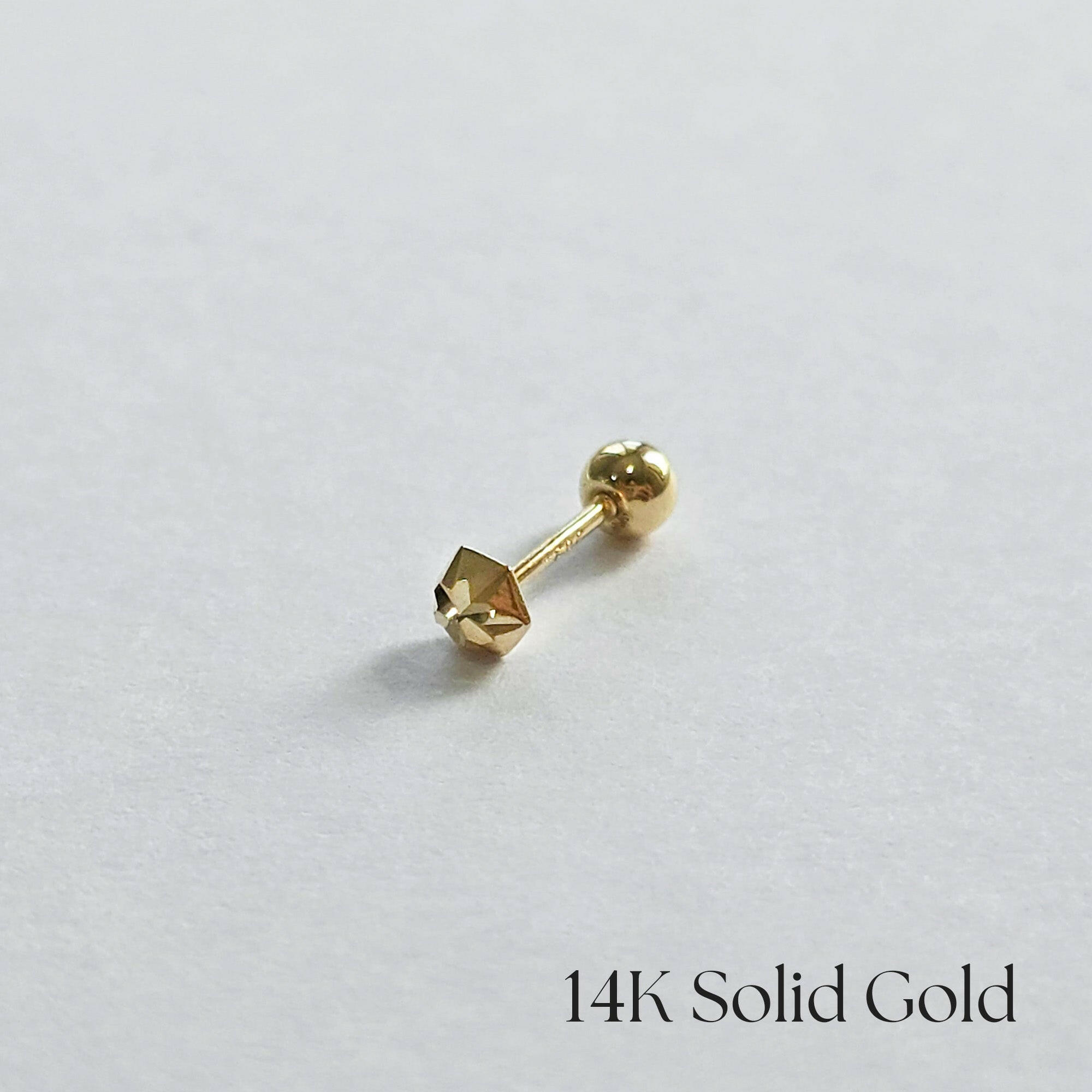 Minimalist hexagon cartilage earring on white backdrop
