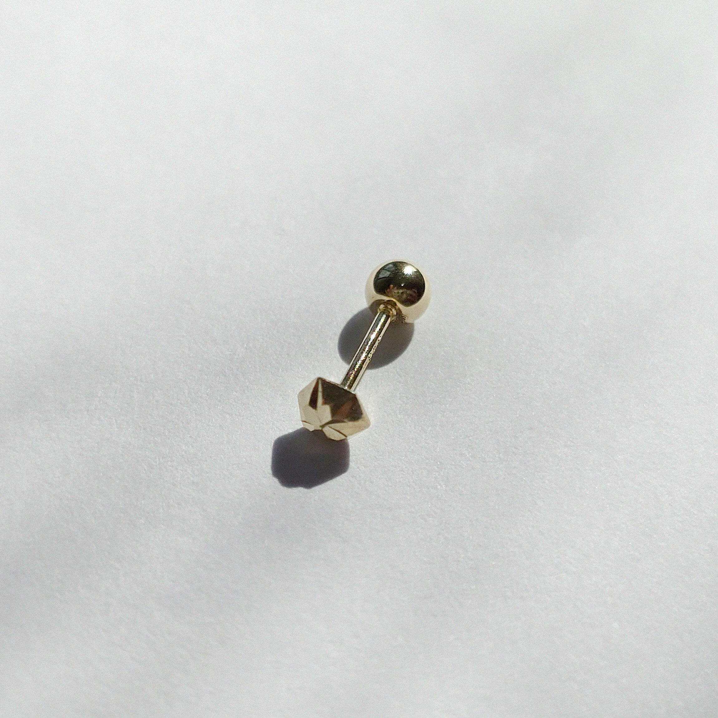 Screwball back with Shiny Hexagon Cartilage Earring fully visible