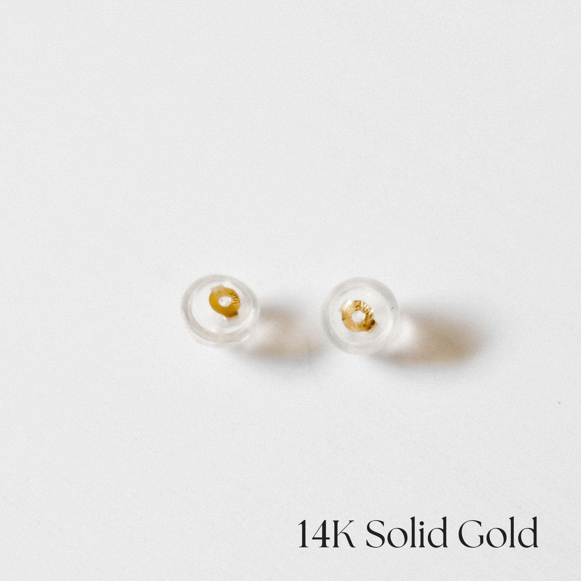 14K gold core silicone earring backs displayed flat on neutral background