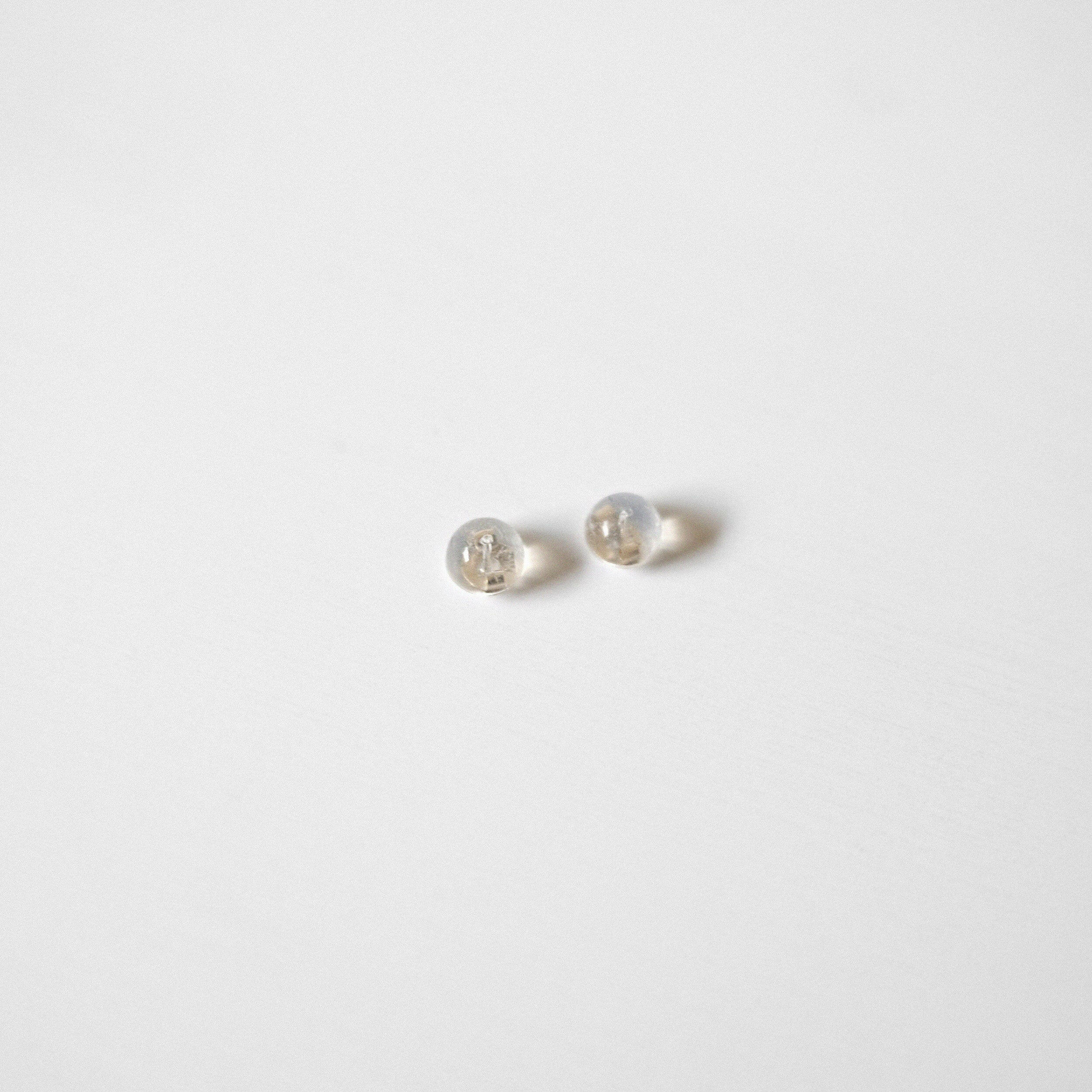 Pair of clear silicone earring backs with visible 14K yellow gold core
