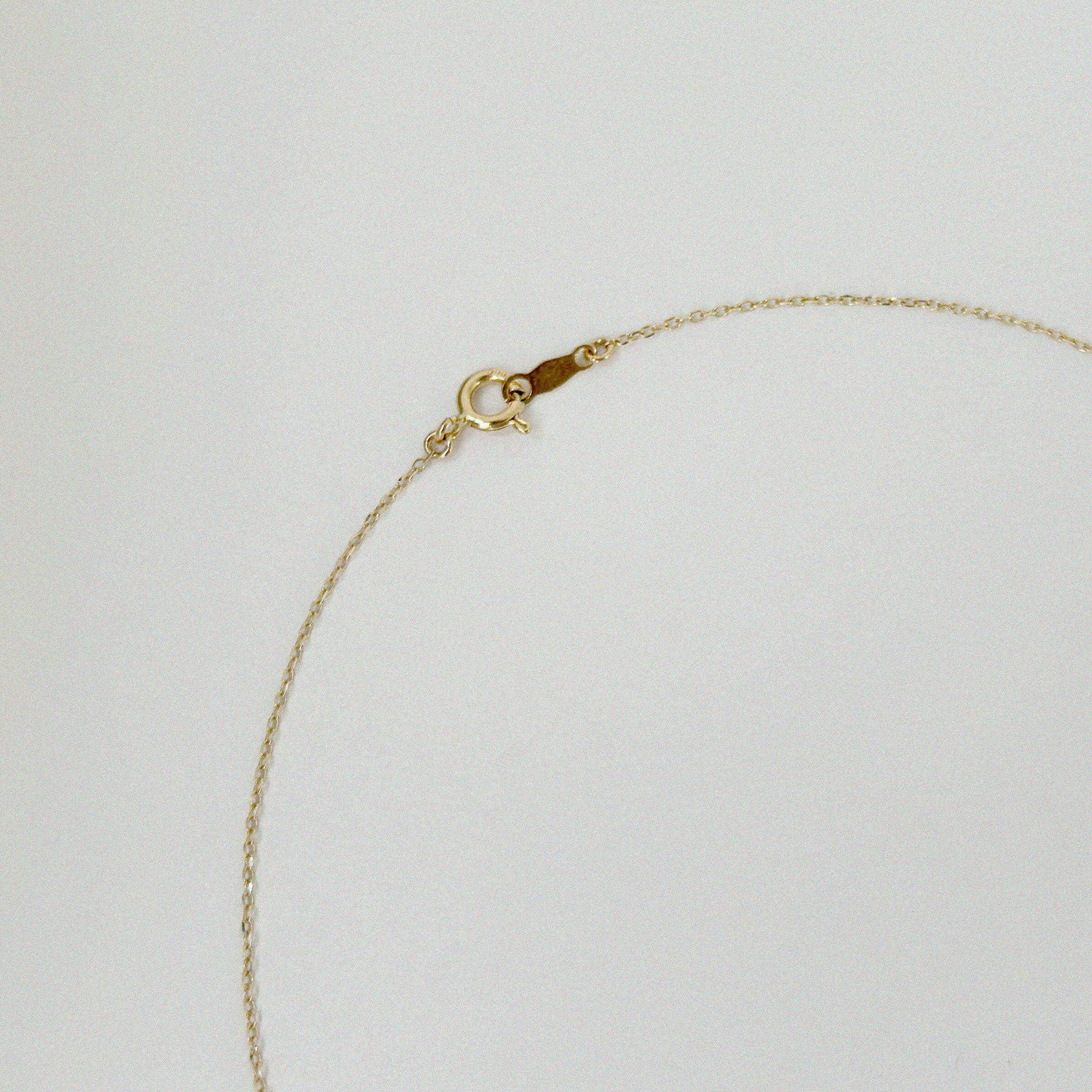 Spring ring clasp of 14K necklace with high-polish finish and secure O-ring closure