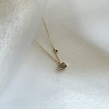 Angled view of Aurora Labradorite Necklace highlighting the bezel setting and stone's layered light play