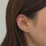 Close-up of ear with Square Crystal Cartilage Earring worn alone for a minimalist look