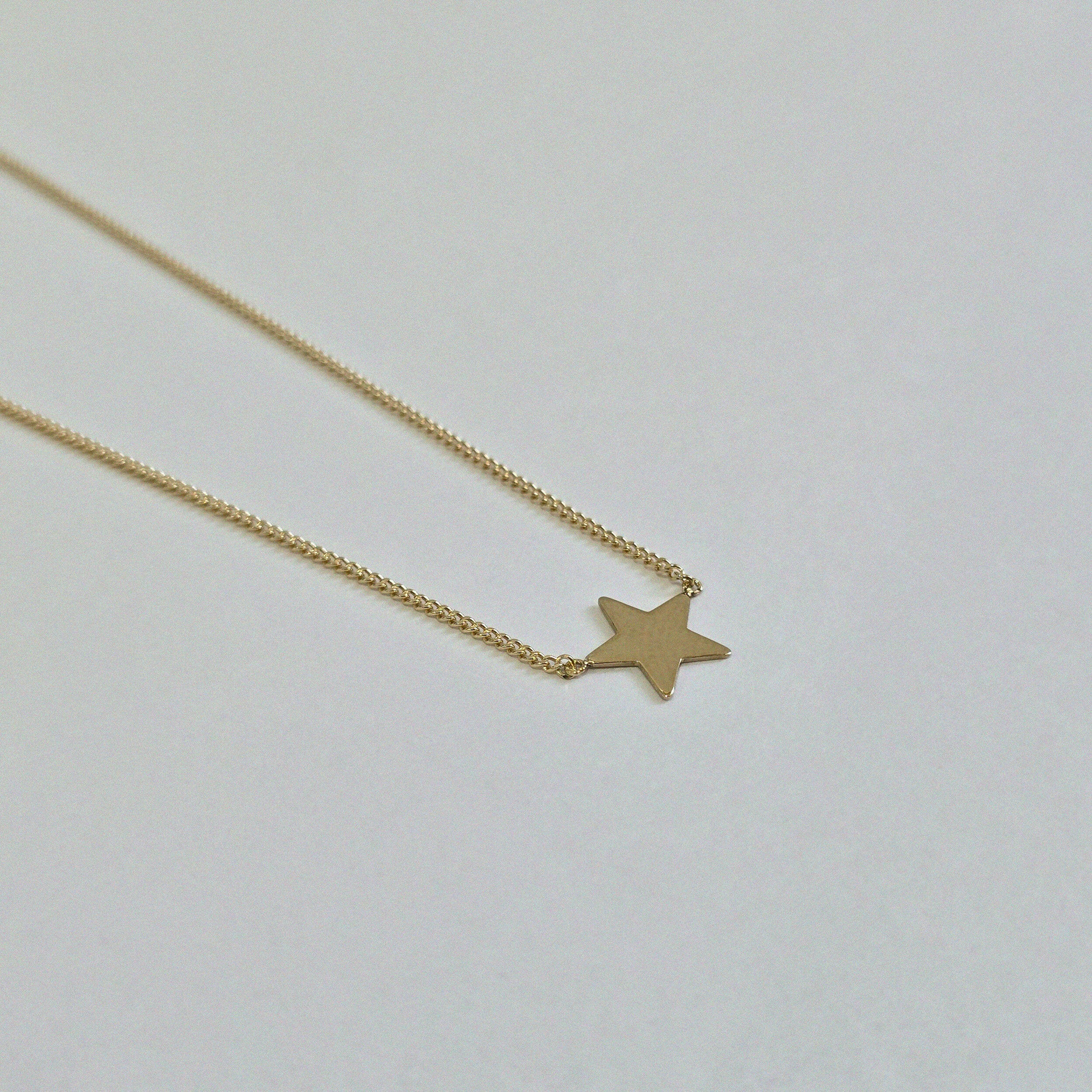 Macro shot of 14K gold star pendant with high-polish finish – Stella Mia Necklace