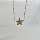 Beveled edges of star pendant glistening in studio light