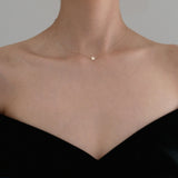 Model wearing Stella Mia Star Necklace styled with black off-shoulder top – celestial elegance