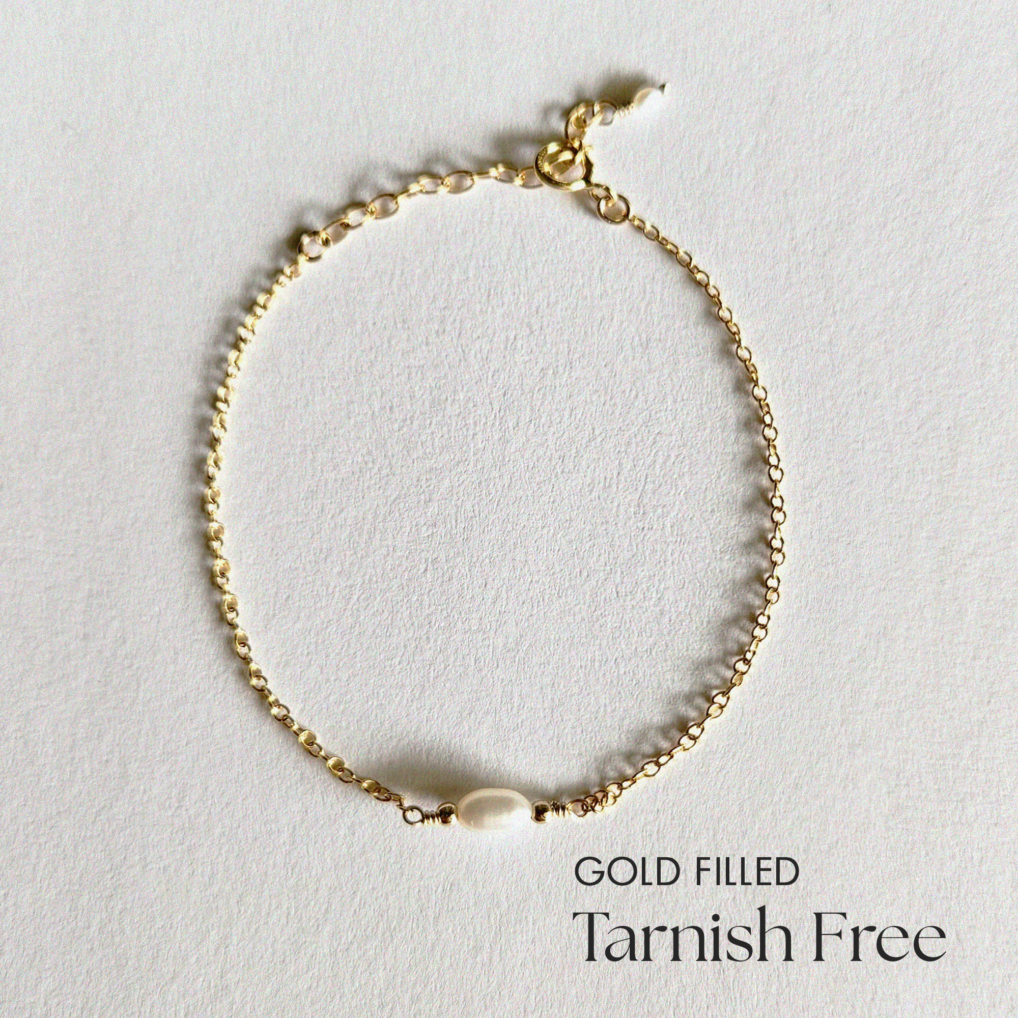 Top view of Syros Bracelet showcasing pearl and gold chain contrast