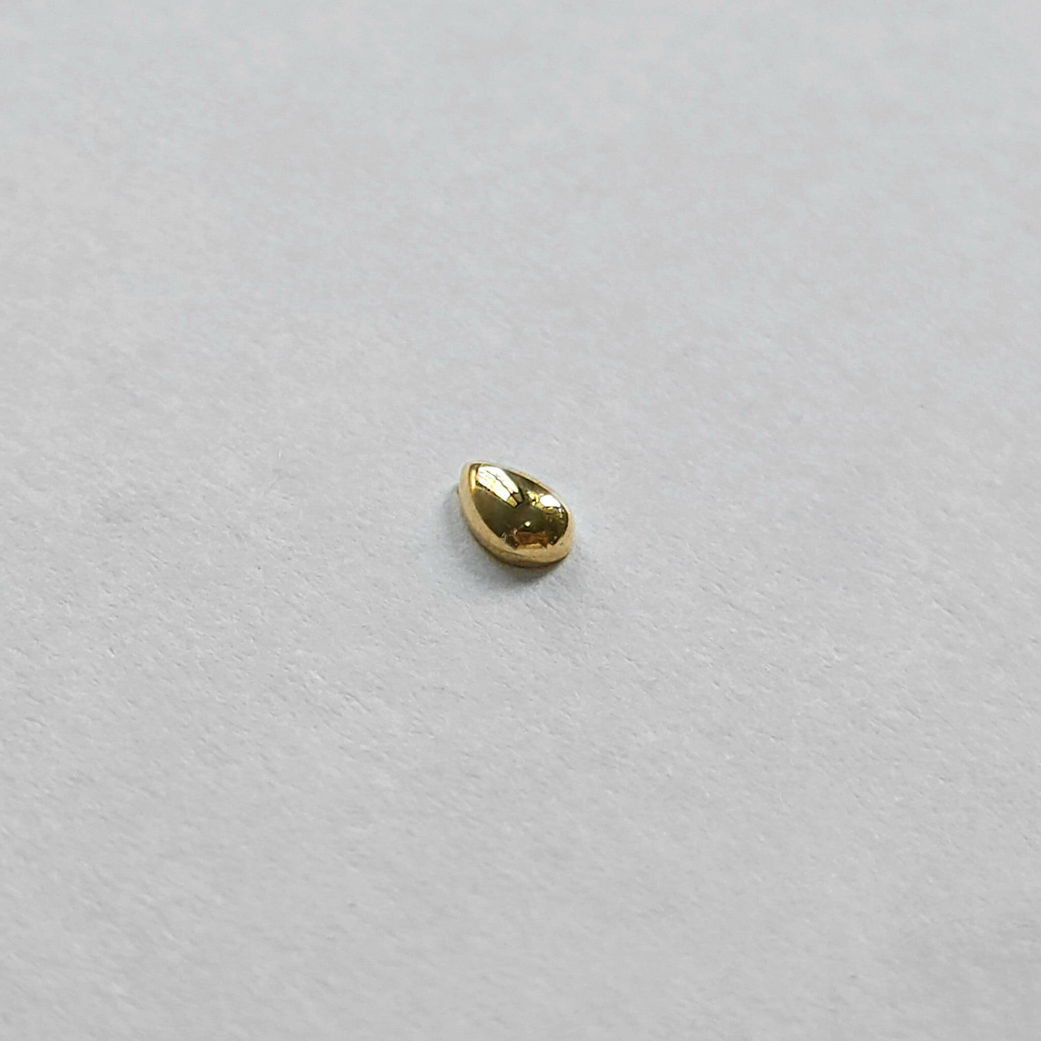 Polished teardrop-shaped cartilage stud on clean white background